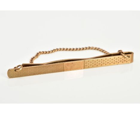 A 9CT GOLD TIE PIN, of engine turn design with a vacant cartouche, hallmarked 9ct gold Birmingham H. G &amp; S, length 70mm w
