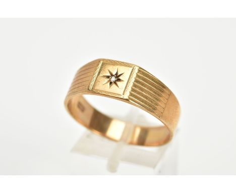 A 9CT GOLD GENTS SIGNET RING, the wide band with a central star set single cut diamond, to the textured shoulders, hallmarked