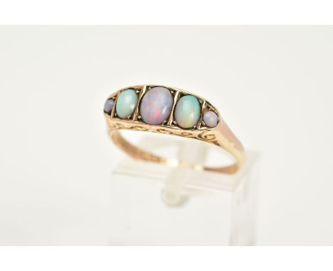 A 9CT GOLD FIVE STONE OPAL RING, designed with graduated oval and circular cut cabochon opals, within a scroll detailed galle