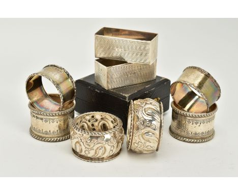 FOUR SETS OF TWO SILVER NAPKIN RINGS, to include a pair of plain polished foliate edge detailed rings, each hallmarked Sheffi