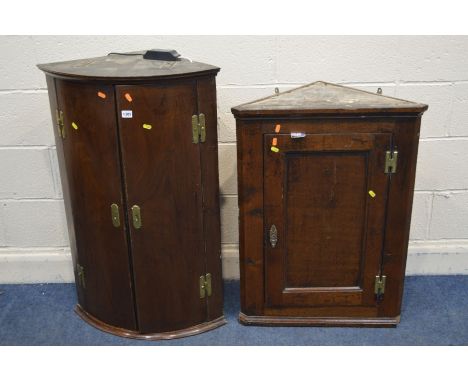 A GEORGIAN MAHOGANY BOW FRONT DOUBLE DOOR HANGING CORNER CUPBOARD, together with another oak hanging corner cupboard (2)