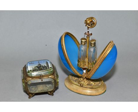 A LATE 19TH CENTURY BLUE OPAQUE GLASS AND GILT METAL EGG SHAPED SCENT BOTTLE HOLDER, the floral and scroll handle when pushed