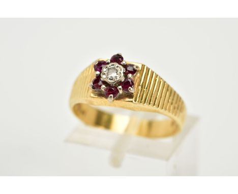 AN 18CT GOLD RUBY AND DIAMOND CLUSTER RING, the tiered cluster set with a central round brilliant cut diamond, within a circu