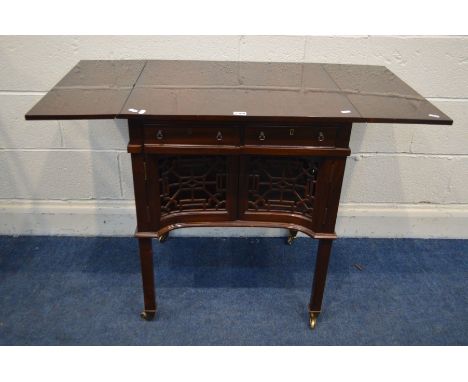 A MAHOGANY SOFA TABLE, with two drawers, double cupboard doors, above fretwork panels, on brass casters, open width 107cm x c