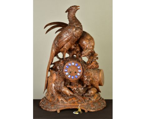 A LATE 19TH CENTURY BLACK FOREST CARVED WALNUT MANTEL CLOCK, with two near life size cock pheasants standing atop of foliage 