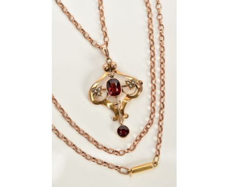 AN EARLY 20TH CENTURY GARNET PENDANT NECKLACE, the openwork pendant/brooch of scroll design, set with a central cushion cut g
