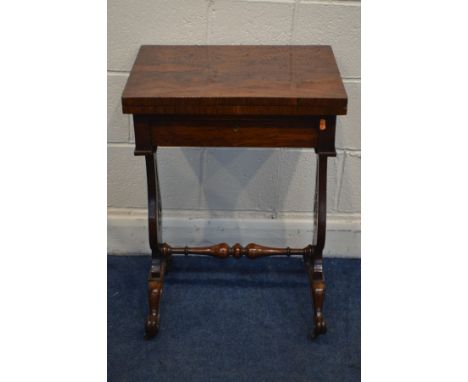 A VICTORIAN ROSEWOOD WORK TABLE, the fold over tope enclosing chess and backgammon boards, single frieze drawer with content,