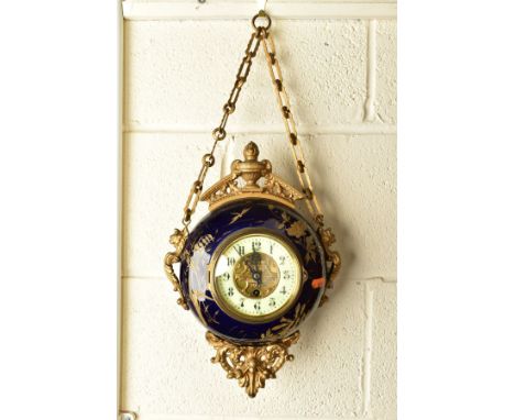 A LATE 19TH CENTURY GILT METAL AND PORCELAIN CASED CIRCULAR WALL HANGING CLOCK, the blue ground with raised gilding of flower