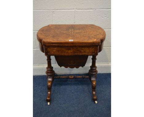 A LATE VICTORIAN BURR WALNUT AND MARQUETRY INLAID WORK TABLE, the fold over top enclosing a chess and back gammon board, sing