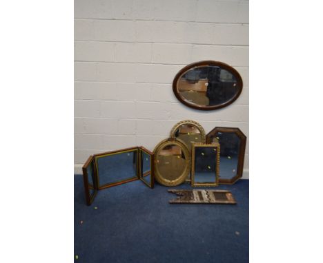 AN EDWARDIAN MAHOGANY OVAL BEVELLED EDGE WALL MIRROR, together with an oak wall mirror with canted corners, three foliate gil