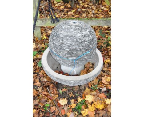 A WOODLODGE LAGOON WATER FEATURE constructed from slate shards around a composite structure with water pump and transformer, 