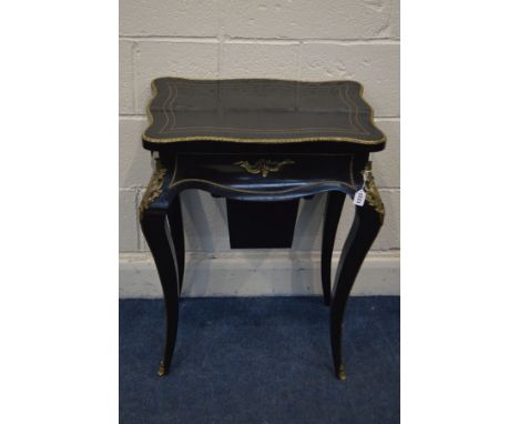 A LATE 19TH CENTURY EBONSIED AND BRASS STRUNG WORK TABLE, in the Louis XV taste, brass ormolu mounts, the wavy top enclosing 