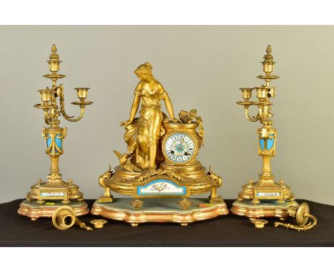 A MID/LATE 19TH CENTURY GILT METAL AND PORCELAIN CLOCK GARNITURE, the clock cast as a classical female figure with doves lean