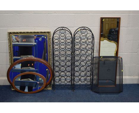 A PAIR OF MODERN BLACK PAINTED WROUGHT IRON WINE RACKS, together with a modern black mesh fire guard, gilt framed bevelled ed