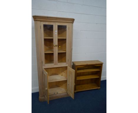 A STANDING PINE CORNER CUPBOARD, double glazed doors enclosing two fixed shelves above panelled double doors enclosing a fixe