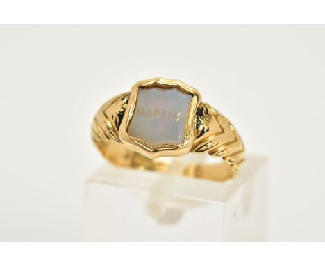 AN 18CT GOLD SIGNET RING, the shield signet engraved with 'Mizpah', within a collet mount and foliate designed black enamel s
