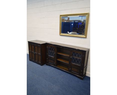 A SLIM DARK OAK BOOKCASE, flanked by lead glazed doors, width 163cm, a similar two door TV cabinet and a modern gilt framed b