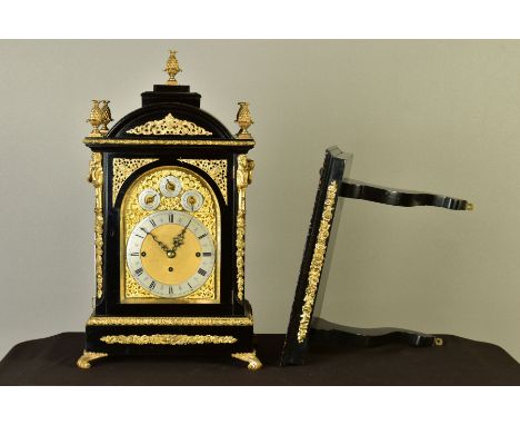 A LATE 19TH CENTURY GEORGE III STYLE EBONISED AND GILT METAL STRIKING AND QUARTER CHIMING BRACKET CLOCK, the domed top with s