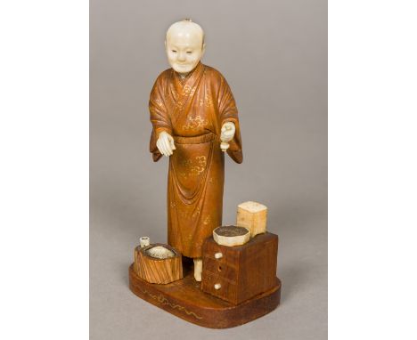 A Japanese Meiji period ivory and wood okimonoFormed as an elderly gentleman wearing a gilt heightened robe.  12.5 cm high.  