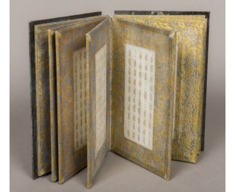 A Chinese bookThe carved cover enclosing the fabric framed inscribed mutton fat jade pages.  23 cm high.    CONDITION REPORTS