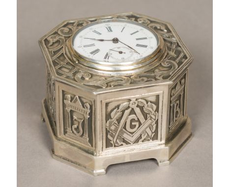 An unmarked silver cased desk timepieceThe hinged lid inset with a plated watch, the white enamelled dial with Roman and Arab