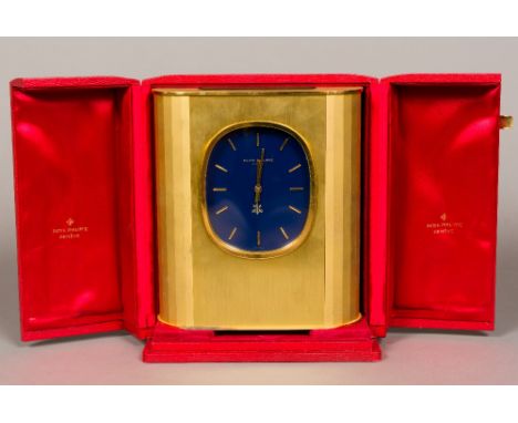 A Patek Philippe Ellipse D'Or Solar clock The blue dial with batons, in the gilt brushed brass case, housed in original plush