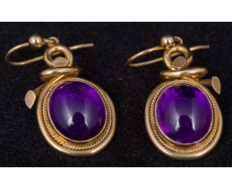 A pair of Victorian unmarked gold amethyst set earringsThe closed back stone cabochon cut.  Approximately 3.3 cm long.    CON