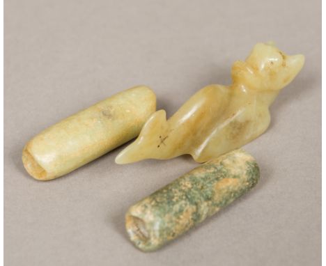 Two Chinese carved jade beads, possibly Neolithic Together with a Chinese carved jade pendant worked as a baby mythical beast