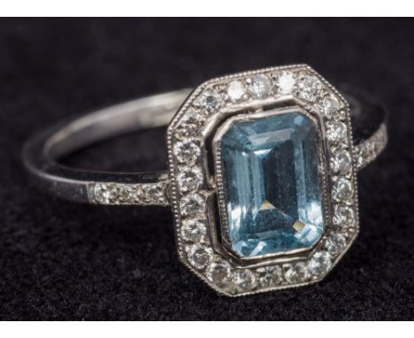 An 18 ct white gold aquamarine and diamond set Art Deco style ringThe central stone emerald cut.     CONDITION REPORTS:  Gene