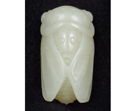 A Chinese carved celadon jade cicada Typically worked.  4.5 cm long.    CONDITION REPORTS:  Generally good condition, expecte