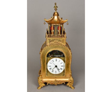 A Chinese gilt metal cased automaton table clockThe 6 inch white painted dial with Roman numerals within gilt spandrels below