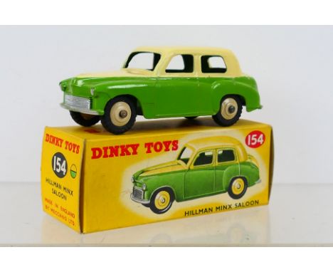 Dinky Toys - A boxed Dinky Toys #154 Hillman Minx Saloon. The model with green lower body and cream upper body, with cream ra