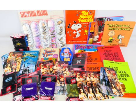 WWE - John Travolta - An assorted collection of WWE items, and vintage adges, games and books, comprising a number of WWE wri
