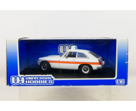 Universal Hobbies - A boxed 1:18 scale universal Hobbies #4452 MGB-GT Police Car. The model shows very dusty signs of display