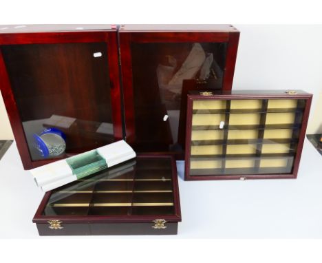 Four wall mounted display cabinets. Lot consists of two cabinets with opening glass door and a series of glass shelves which 