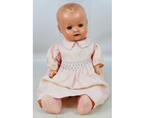 August Steiner - A German bisque head baby doll with sleeping blue eyes and open mouth with upper teeth showing. It is marked