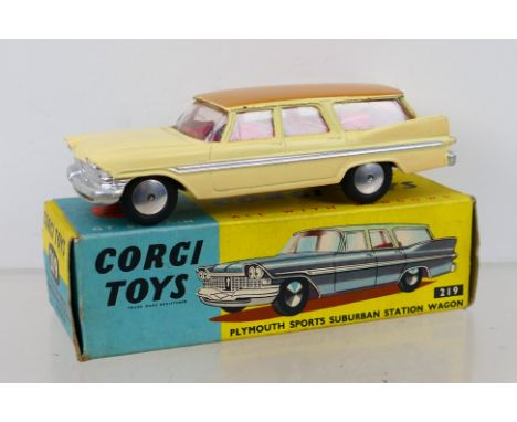 Corgi Toys - A boxed Corgi Toys #219 Plymouth Sports Suburban Station Wagon. The model with cream body, fawn roof, red lemon 