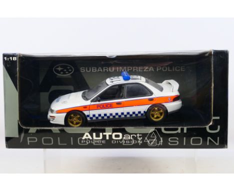 AutoArt - A boxed 1:18 scale AutoArt 'Police Division' #78651 Subaru Impreza Police Car. The model shows dusty signs of displ