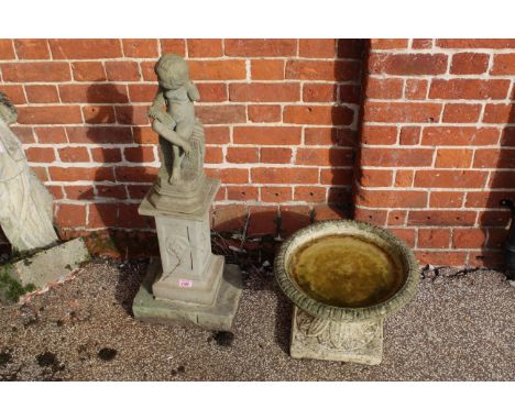A modern garden statue of a boy (as found) with bird bath