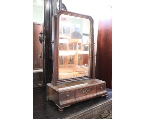 A George III mahogany toilet mirror on three drawer base with ogee feet 