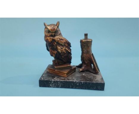 A table lighter in the form of an Owl resting on books