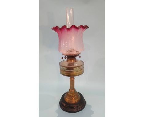 A Victorian oil lamp, with cranberry and etched glass shade