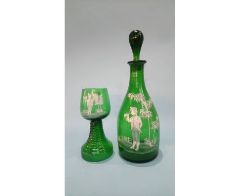 A green glass decanter painted with enamels and matching goblet