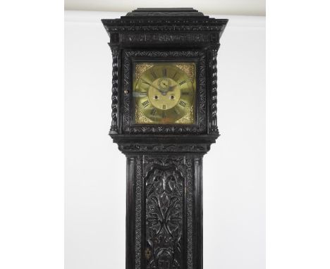 A mid-18th century longcase clock by Robert Davis of Burnley with later carved oak case, the longcase has profuse relief carv