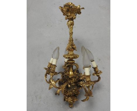 A rococo style gilt metal six branch chandelier with suspension loop and bracket, the central column cast with fruiting vine 