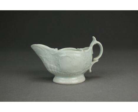 A Caughley porcelain cream jug,circa 1785-90,undecorated, with delicate relief scroll moulding, high spur to the handle, unma