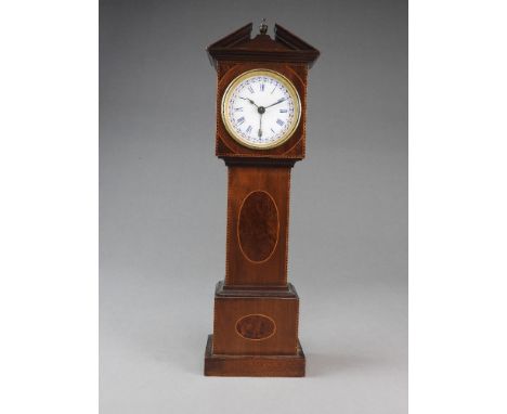 An early 20th century French inlaid mahogany miniature longcase clock with calendar, the case is inlaid with two mulberry ova