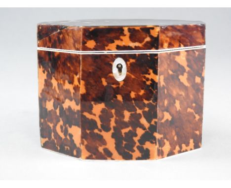 A George III hexagonal tortoiseshell tea caddy with tortoiseshell veneered inner cover and ivory borders, mother of pearl esc