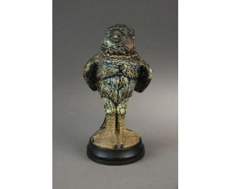 A small Martin Brothers' stoneware jar and cover designed by Robert Wallace Martin,dated 22.21.1913, the bird with piercing h