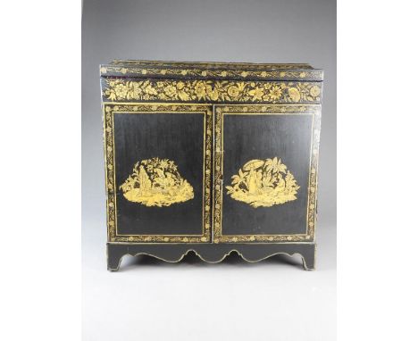 A chinoiserie lacquered collectors' cabinet, early 19th century with lift top enclosing a mirrored and lined interior above t